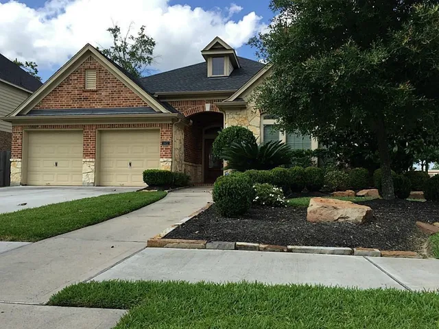 a front view of a house with a yard and a garage