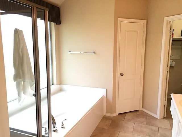 a bathroom with a tub and shower