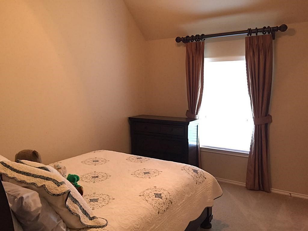 1602 Eden Meadows Drive Spring, TX 77386 - Photo 16 of 25 a bedroom with a bed and a window