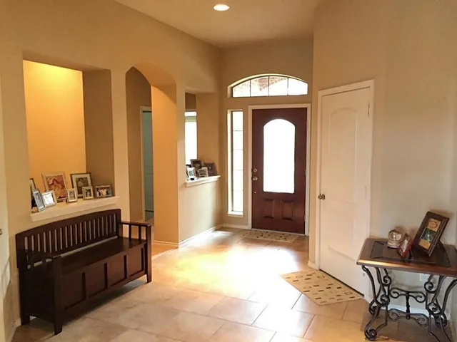 a view of a hallway with wooden floor and a swimming pool
