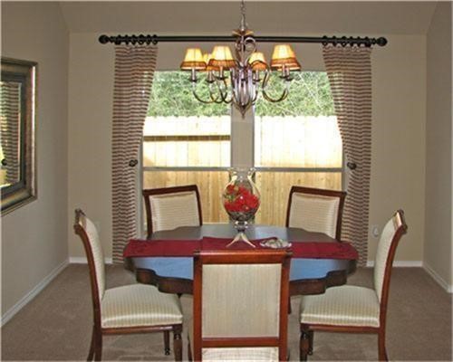 1602 Eden Meadows Drive Spring, TX 77386 - Photo 7 of 25 a view of a dining room with furniture a chandelier and large window