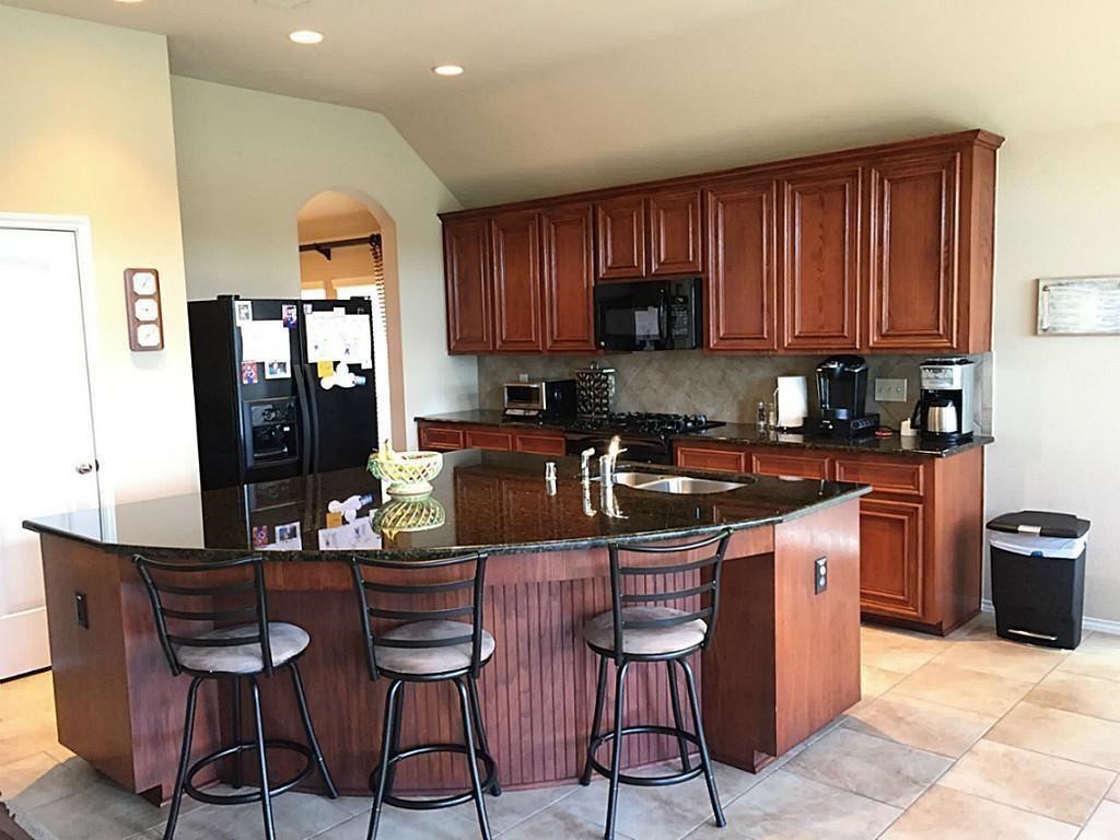 1602 Eden Meadows Drive Spring, TX 77386 - Photo 8 of 25 a kitchen with granite countertop a sink cabinets and stainless steel appliances