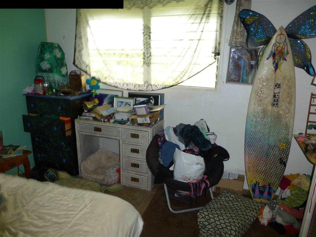 1765 Haiku Road Haiku, HI 96708 - Photo 22 of 25 a bed room with a bed and a window