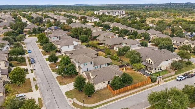 an aerial view of a residential houses with outdoor space