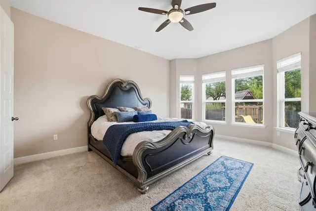 a kitchen with stainless steel appliances a dining table chairs stove and white cabinets