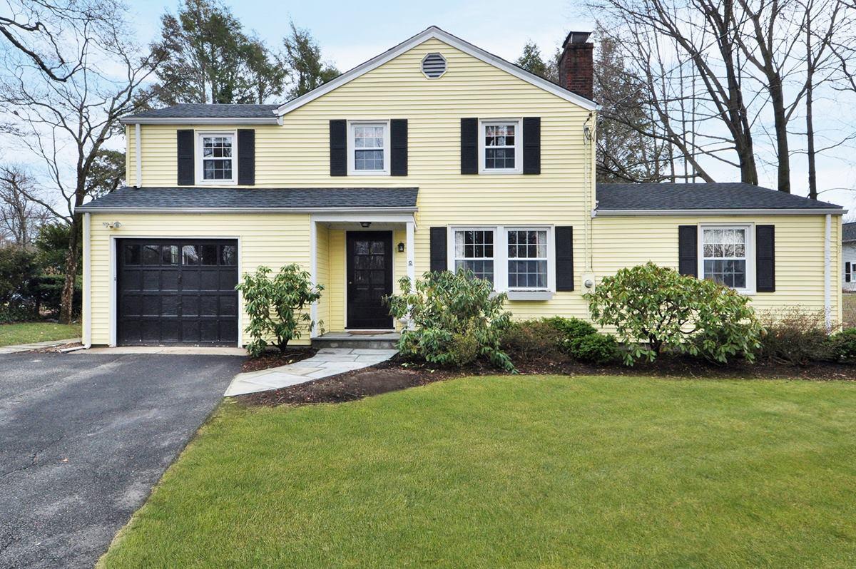 112 Hollow Tree Ridge Road Darien, CT 06820 - Photo 1 of 27 a front view of a house with a garden and yard