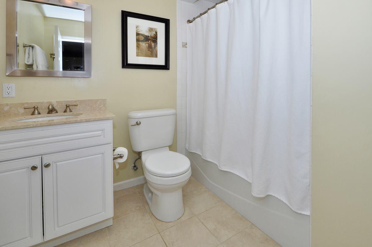 112 Hollow Tree Ridge Road Darien, CT 06820 - Photo 12 of 27 a bathroom with a toilet a sink and vanity
