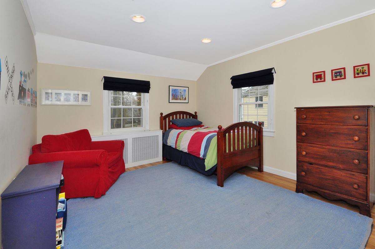 112 Hollow Tree Ridge Road Darien, CT 06820 - Photo 19 of 27 a bedroom with a bed and a couch