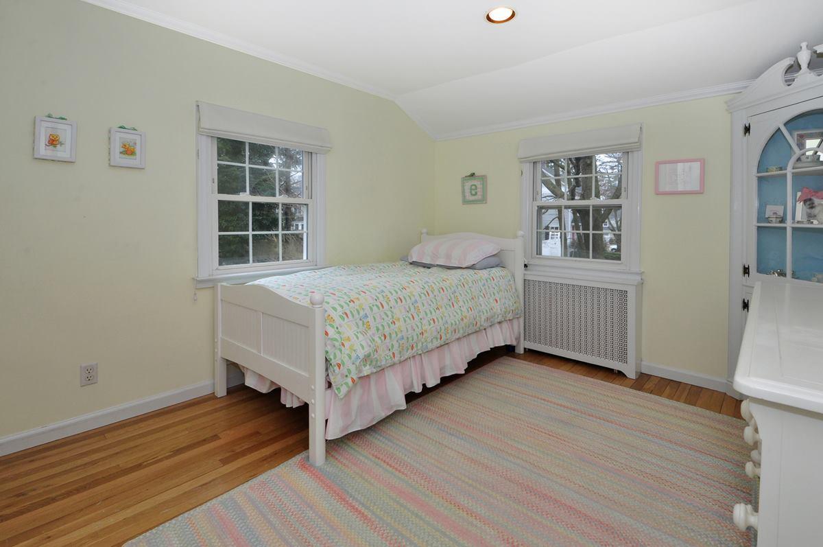 112 Hollow Tree Ridge Road Darien, CT 06820 - Photo 20 of 27 a bedroom with a bed and a window