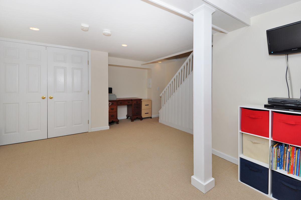112 Hollow Tree Ridge Road Darien, CT 06820 - Photo 22 of 27 a view of empty room with wooden floor and fan