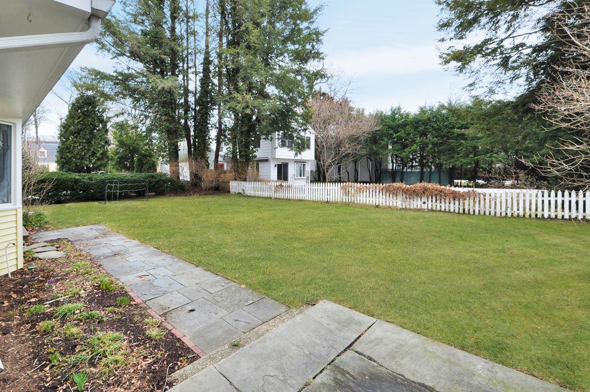 112 Hollow Tree Ridge Road Darien, CT 06820 - Photo 24 of 27 a view of a house with a yard and sitting area