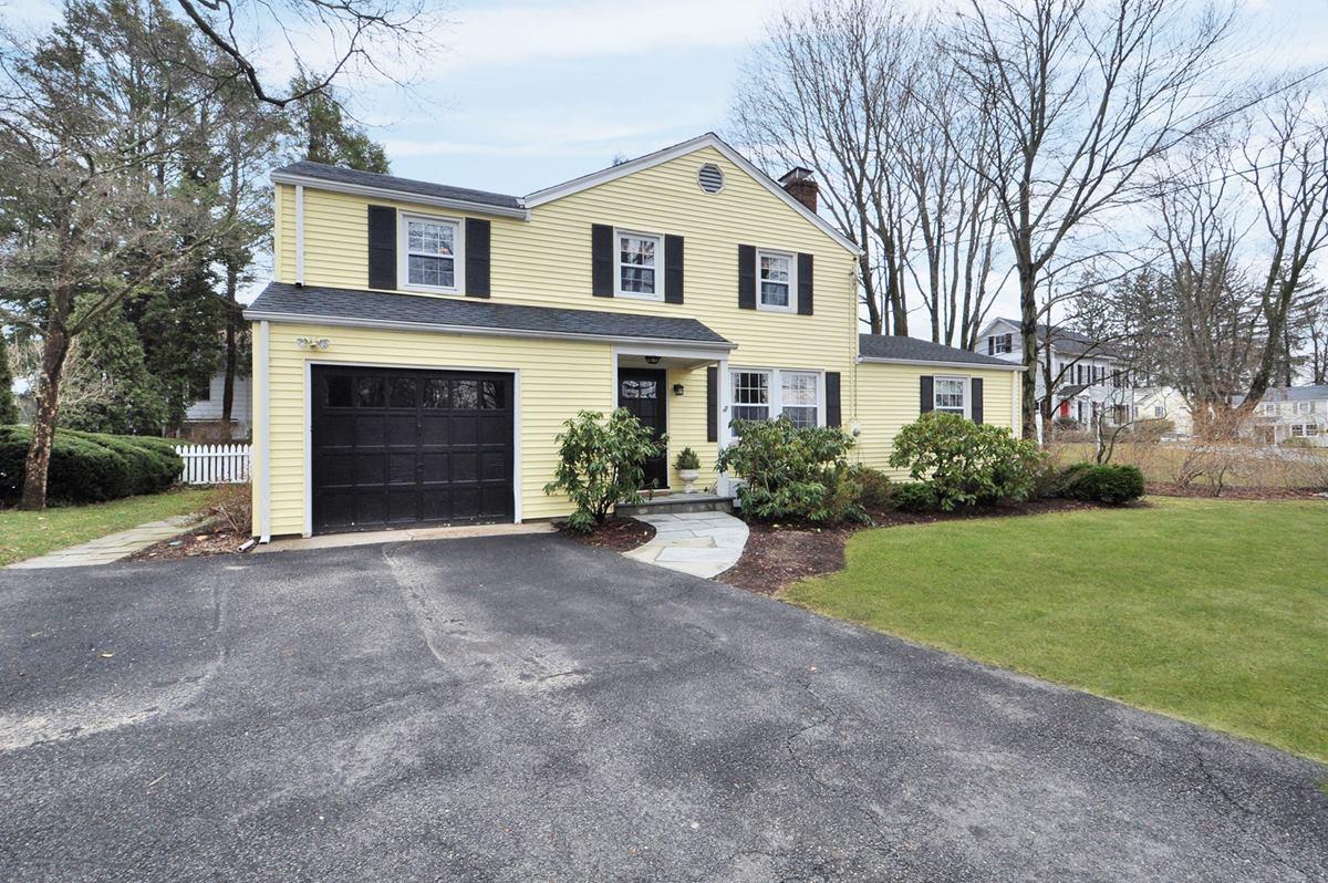 112 Hollow Tree Ridge Road Darien, CT 06820 - Photo 26 of 27 a front view of a house with a yard and garage