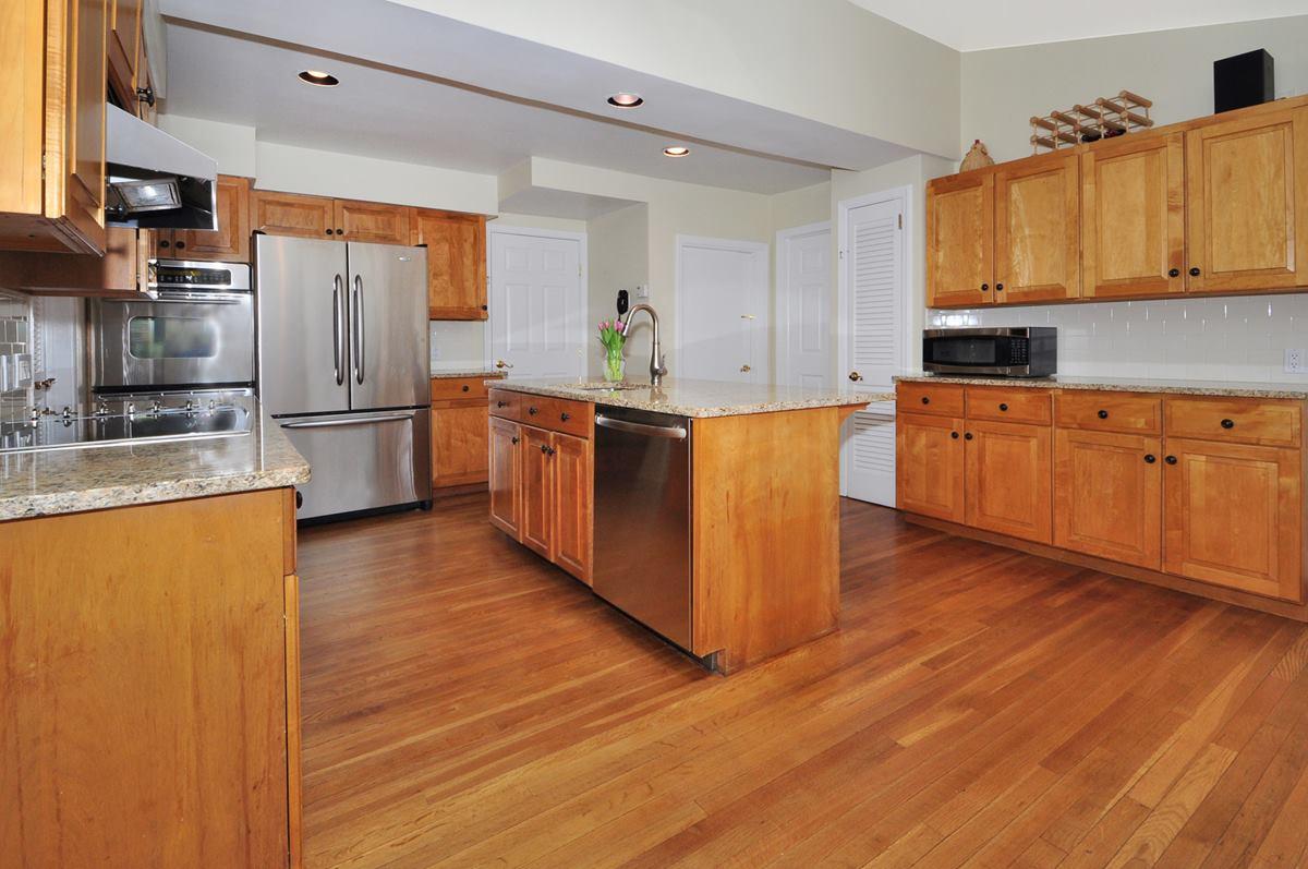 112 Hollow Tree Ridge Road Darien, CT 06820 - Photo 8 of 27 a large kitchen with stainless steel appliances granite countertop a refrigerator a stove a sink and a microwave