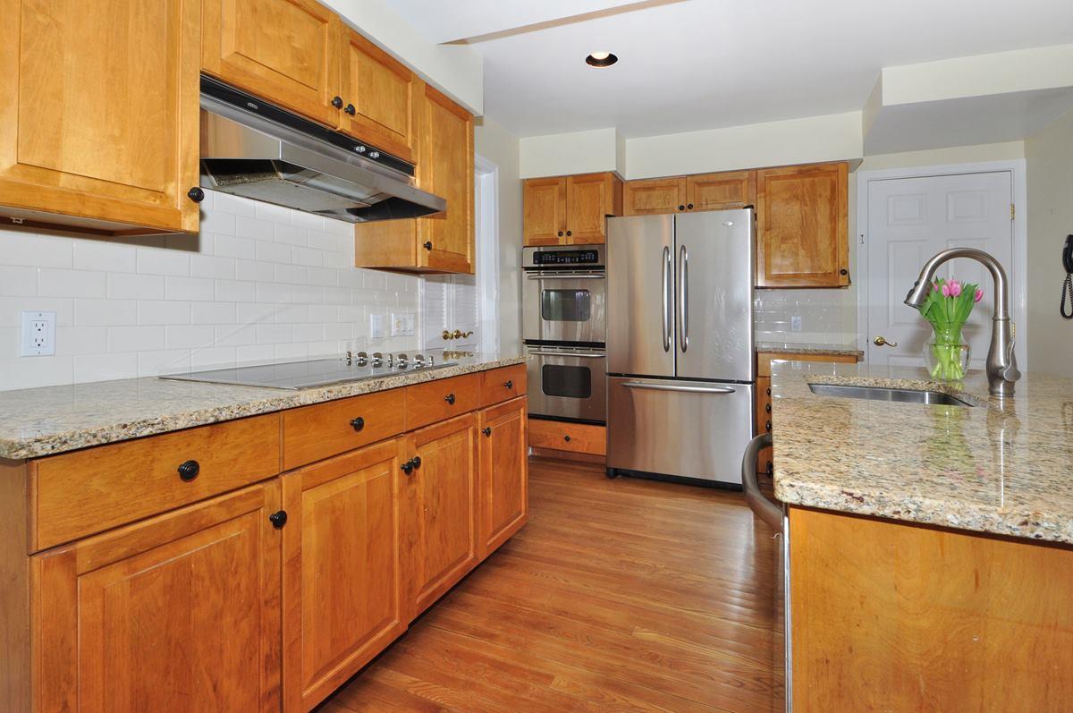 112 Hollow Tree Ridge Road Darien, CT 06820 - Photo 9 of 27 a kitchen with stainless steel appliances granite countertop a refrigerator a sink and a stove