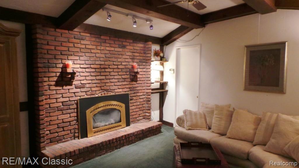 2218 Lone Tree Road Highland, MI 48357 - Photo 16 of 25 Family room fireplace