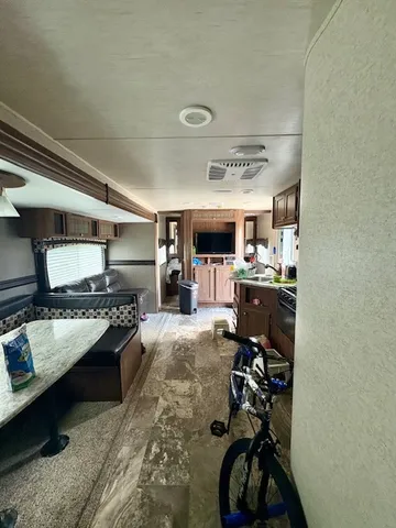 a kitchen with kitchen island granite countertop a refrigerator stove and microwave