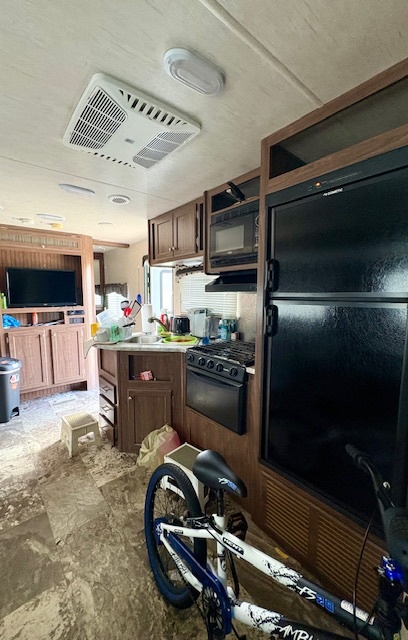 25-126 Woodhaven Sublette, IL 61367 - Photo 12 of 17 a kitchen with kitchen island granite countertop a refrigerator stove and microwave