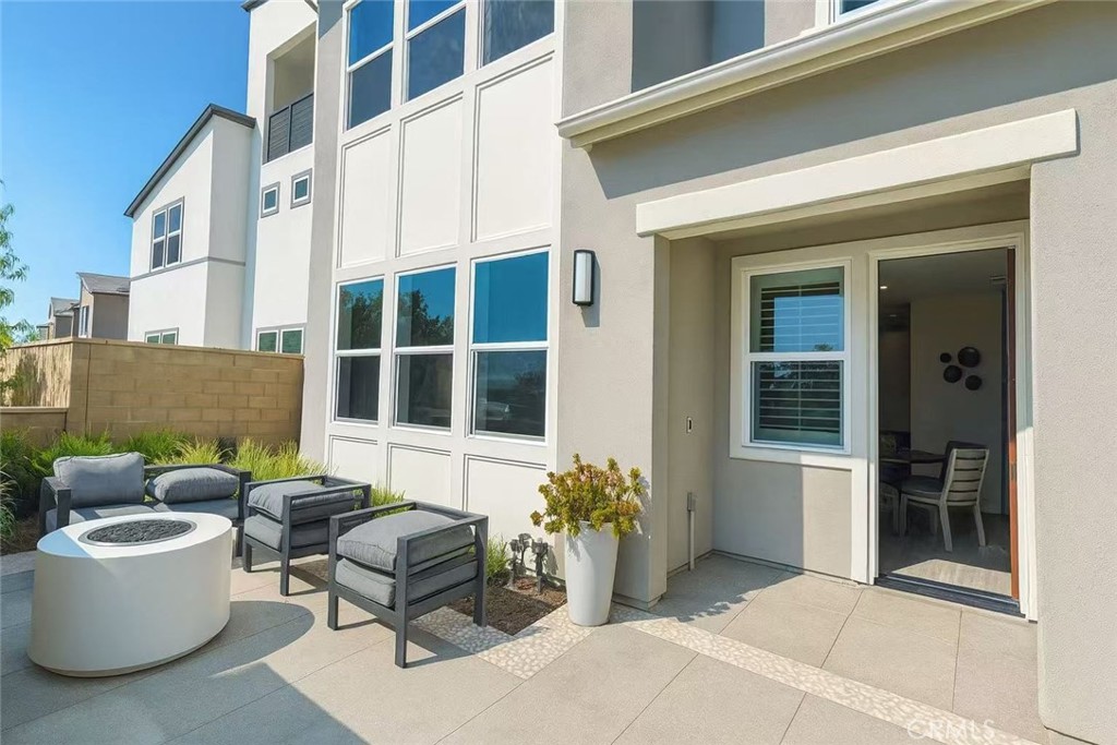609 Gadwall Irvine, CA 92618 - Photo 4 of 10 a view of a patio with couches table and chairs and potted plants