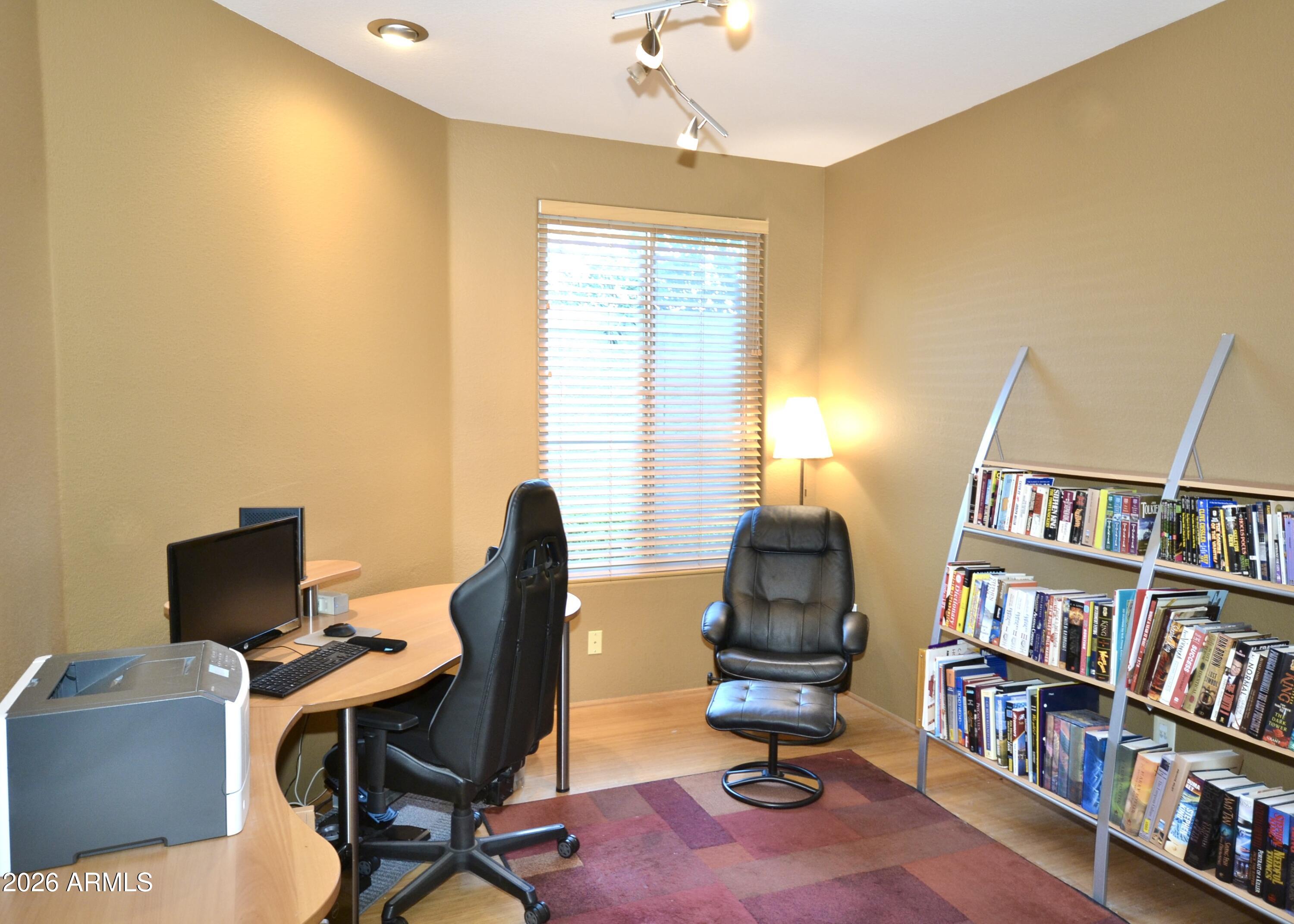 5303 North 7th Street, Unit 117 Phoenix, AZ 85014 - Photo 11 of 31 a view of a workspace with furniture and a bookshelf