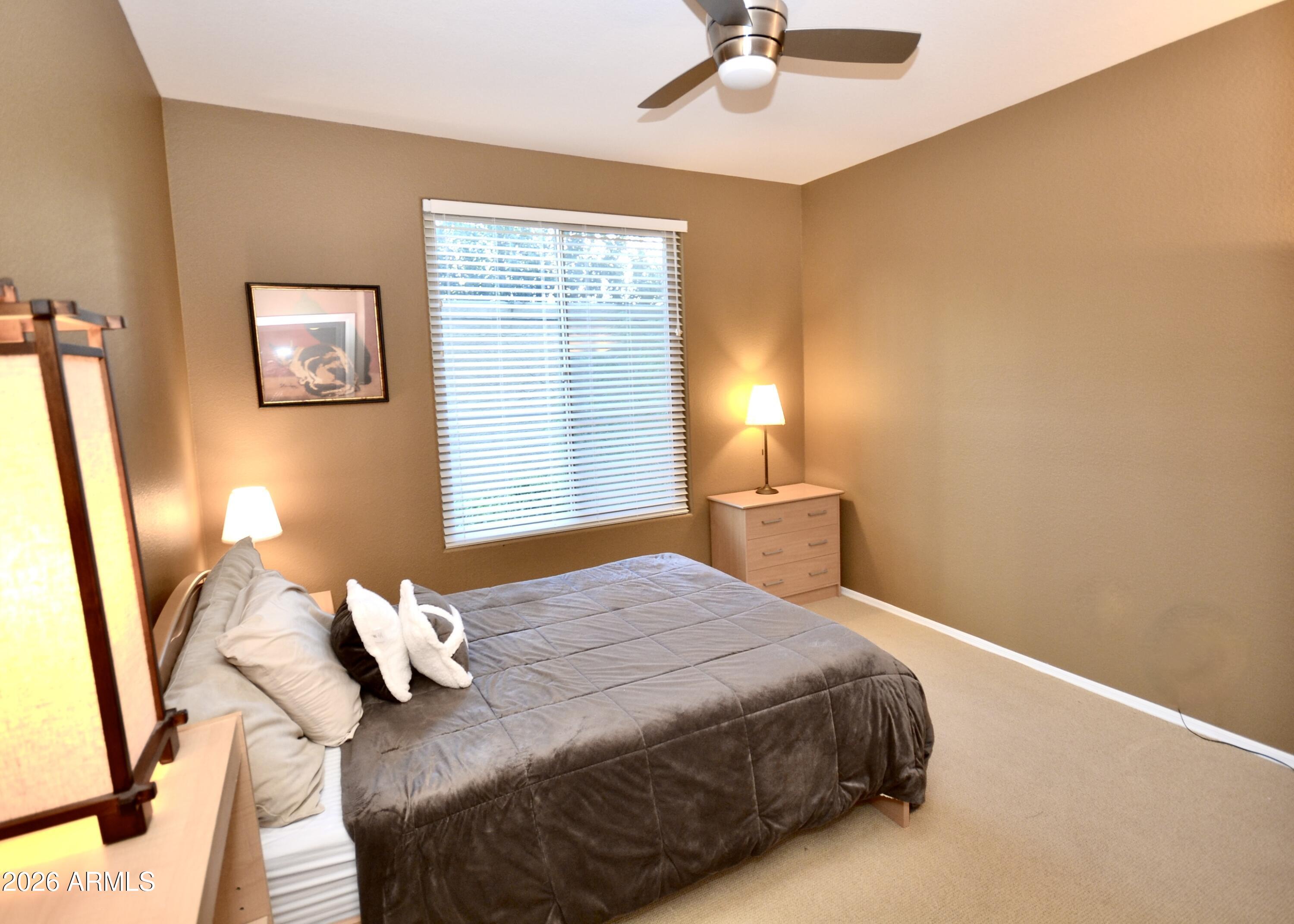 5303 North 7th Street, Unit 117 Phoenix, AZ 85014 - Photo 14 of 31 a bedroom with a bed and wooden floor