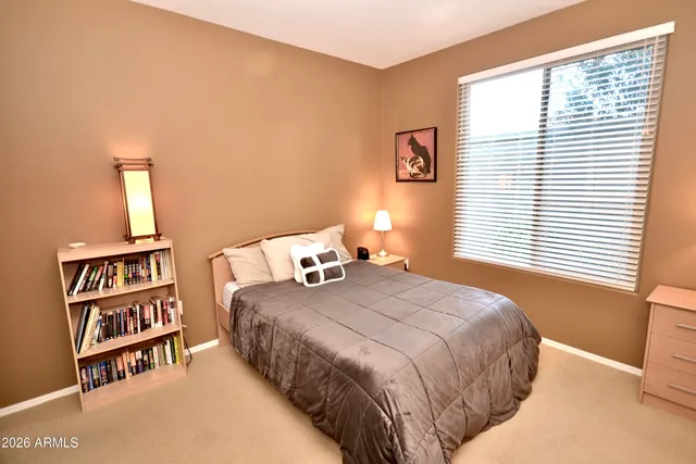 a bedroom with a bed and a book shelf