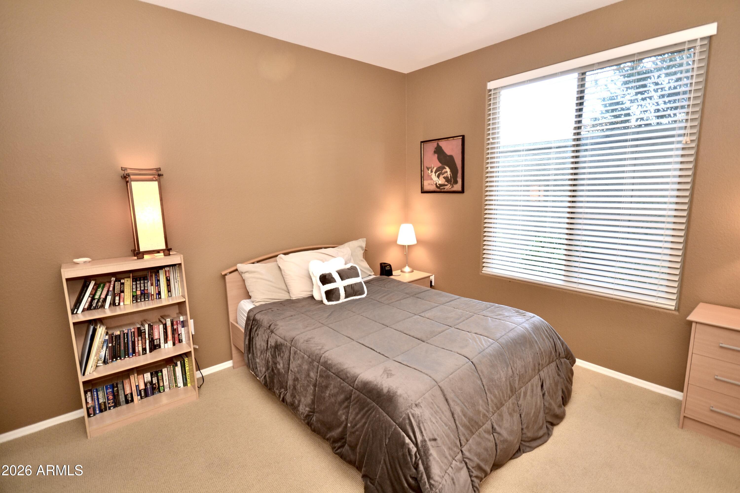 5303 North 7th Street, Unit 117 Phoenix, AZ 85014 - Photo 15 of 31 a bedroom with a bed and a book shelf