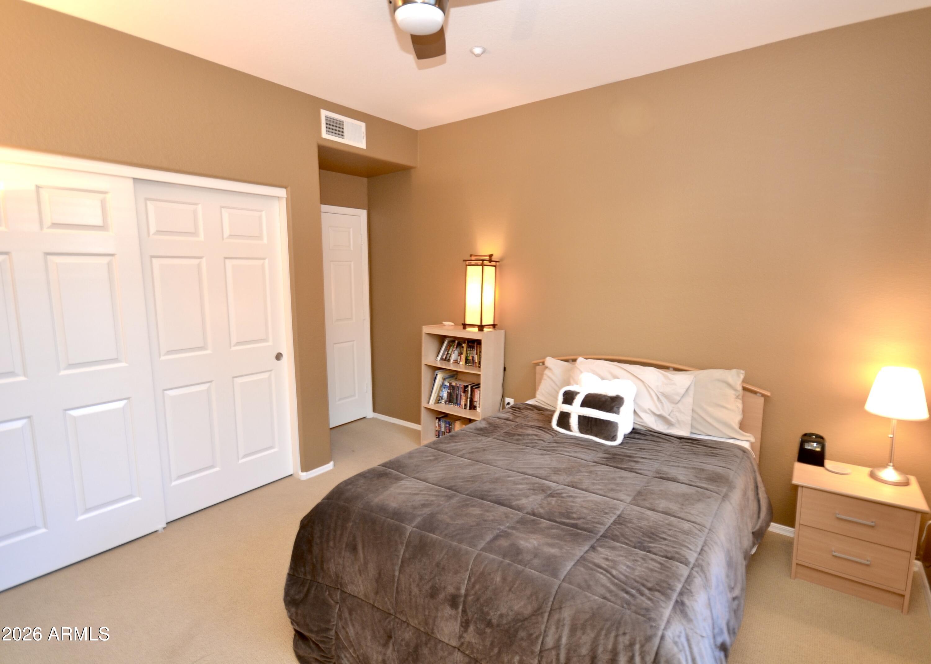 5303 North 7th Street, Unit 117 Phoenix, AZ 85014 - Photo 16 of 31 a bedroom with a bed and a lamp