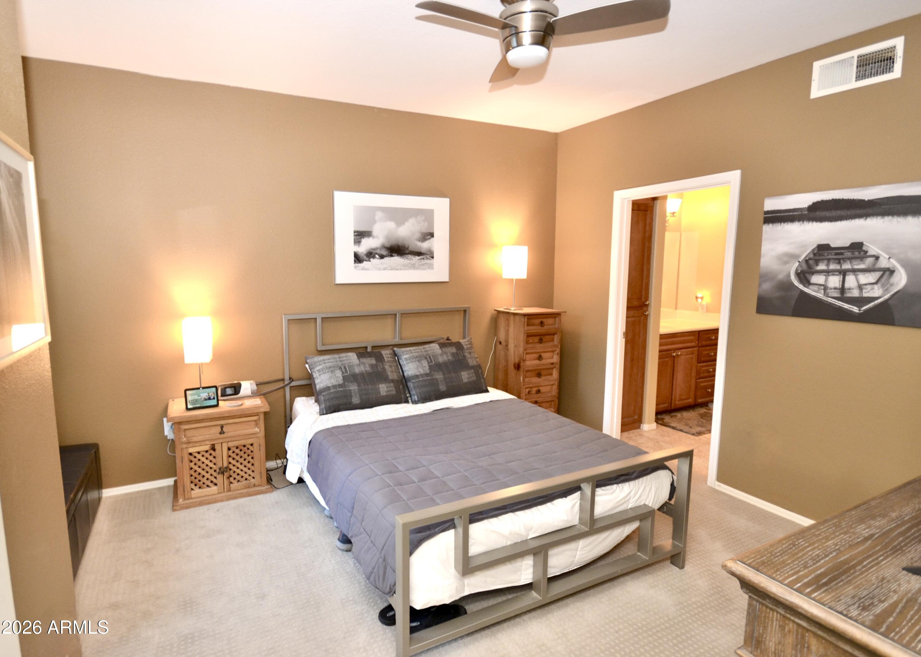 5303 North 7th Street, Unit 117 Phoenix, AZ 85014 - Photo 17 of 31 a bedroom with a bed and painting on the wall