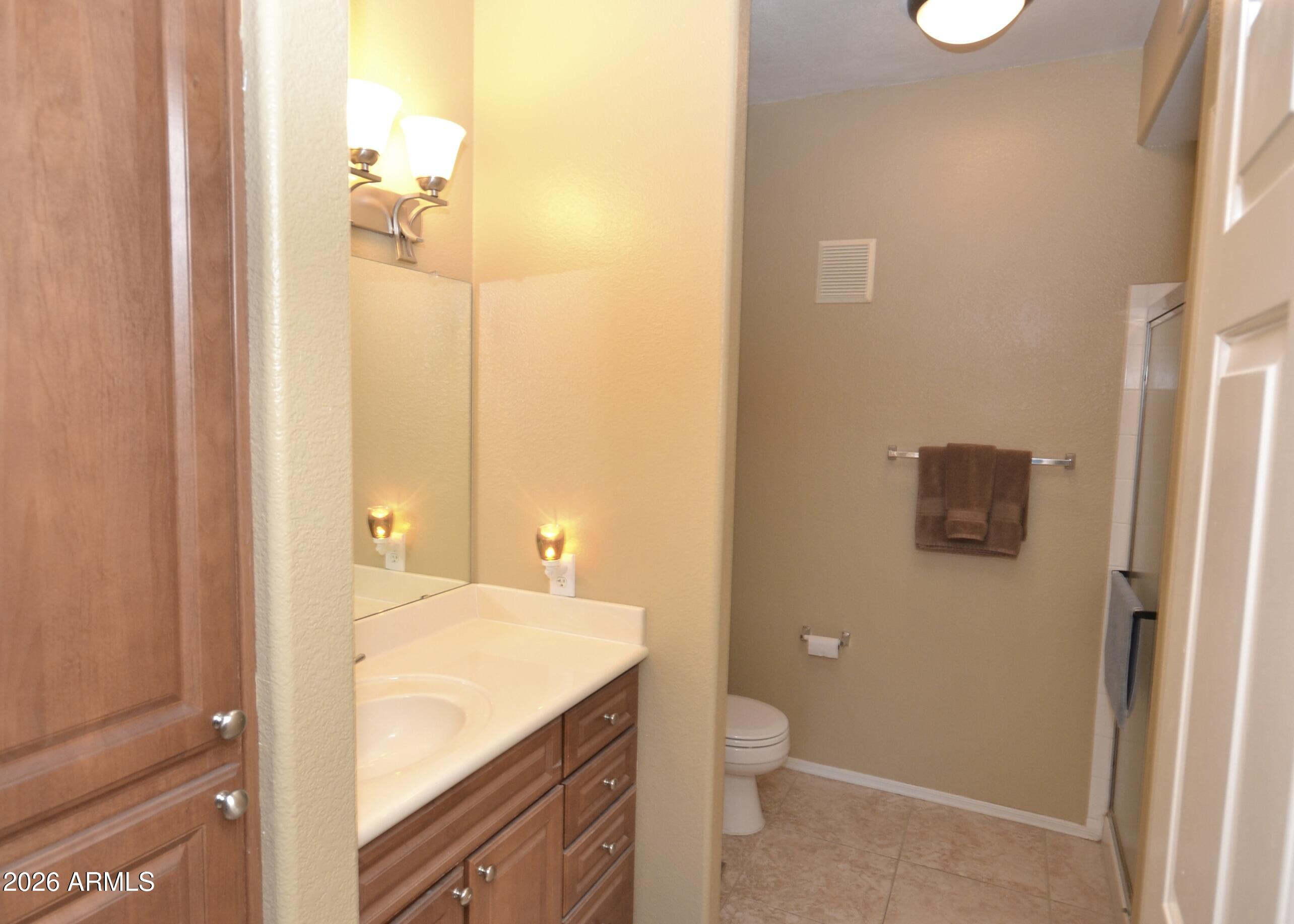 5303 North 7th Street, Unit 117 Phoenix, AZ 85014 - Photo 20 of 31 a bathroom with a granite countertop sink and a mirror