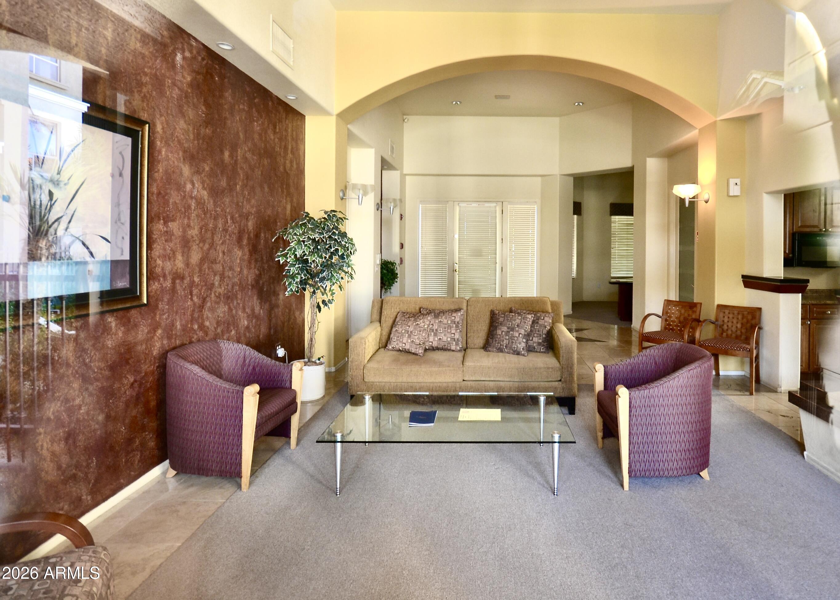 5303 North 7th Street, Unit 117 Phoenix, AZ 85014 - Photo 26 of 31 a living room with furniture a fireplace and large windows