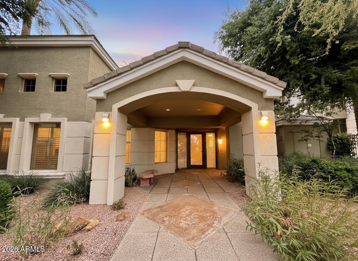 5303 North 7th Street, Unit 117 Phoenix, AZ 85014 - Photo 2 of 31 a view of a house with a small yard and floor to ceiling window and potted plants