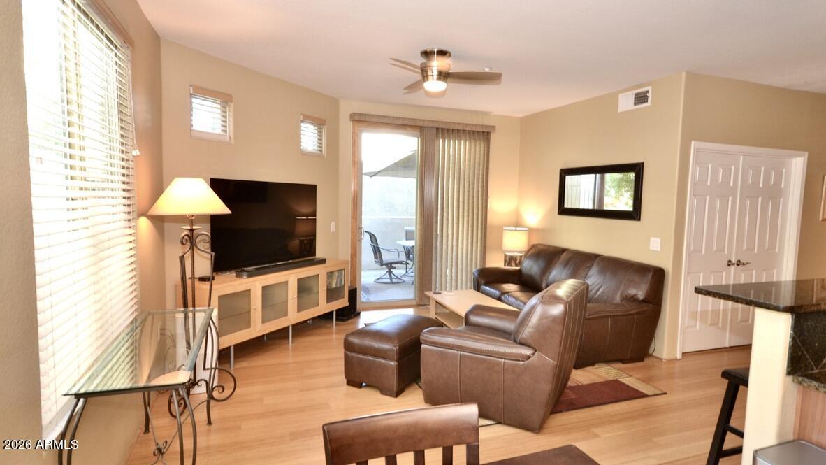5303 North 7th Street, Unit 117 Phoenix, AZ 85014 - Photo 5 of 31 a living room with furniture and a flat screen tv