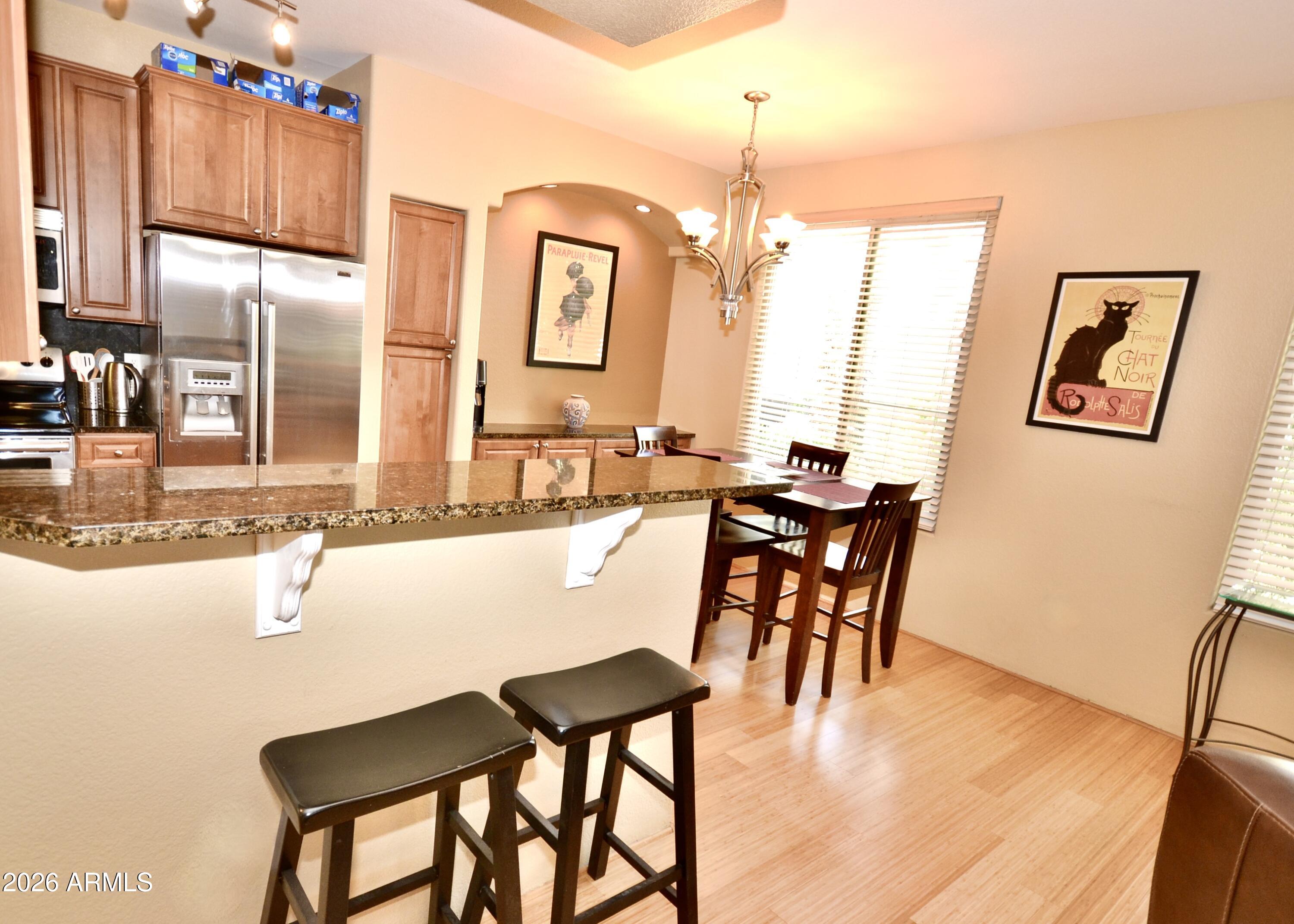 5303 North 7th Street, Unit 117 Phoenix, AZ 85014 - Photo 7 of 31 a dining table with chairs and chandelier