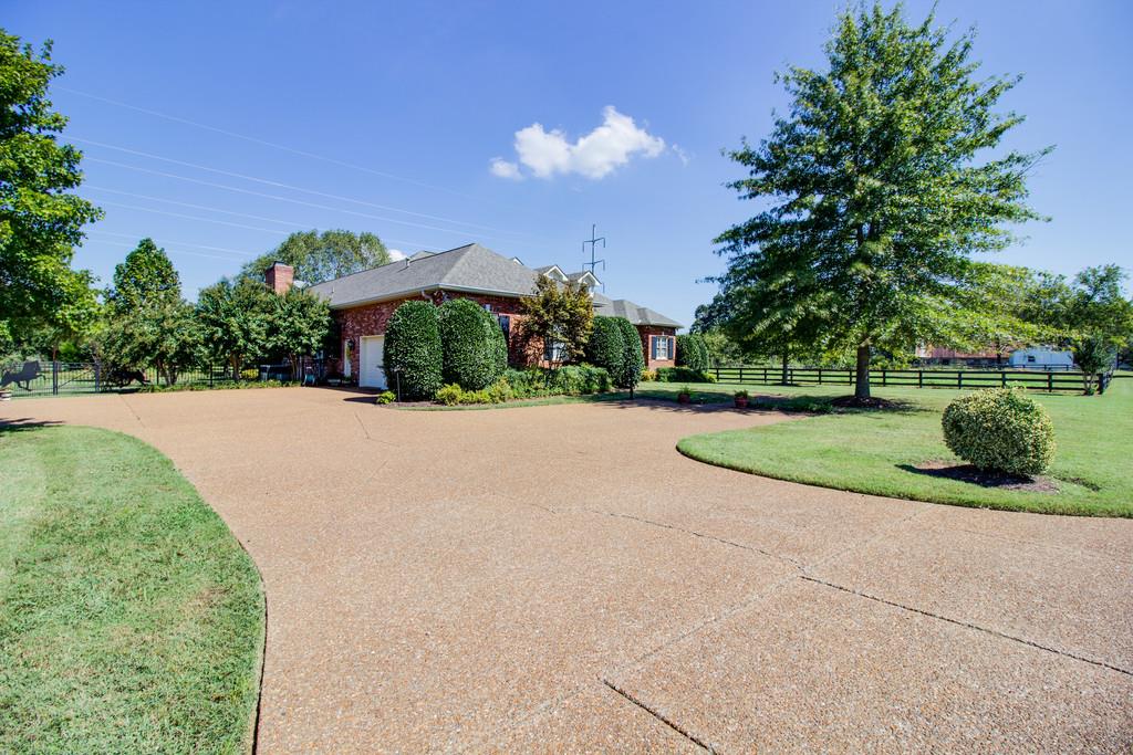 4670 Murfreesboro Road Franklin, TN 37067 - Photo 2 of 30 a view of a garden with a bench
