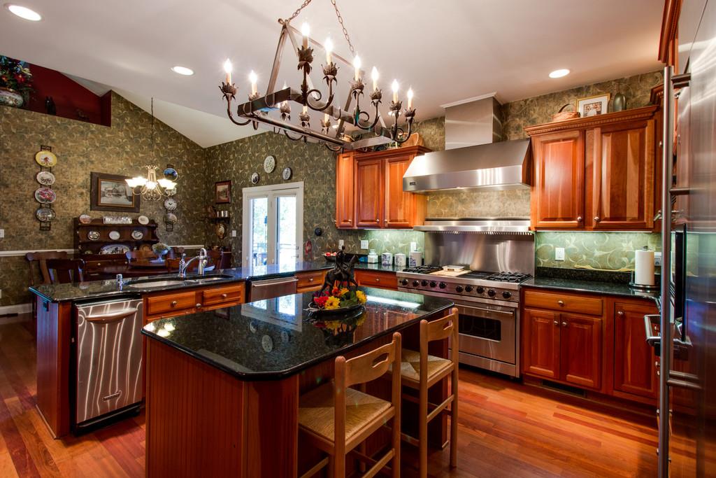 4670 Murfreesboro Road Franklin, TN 37067 - Photo 21 of 30 a kitchen with stainless steel appliances granite countertop a stove a sink dishwasher and cabinets with wooden floor