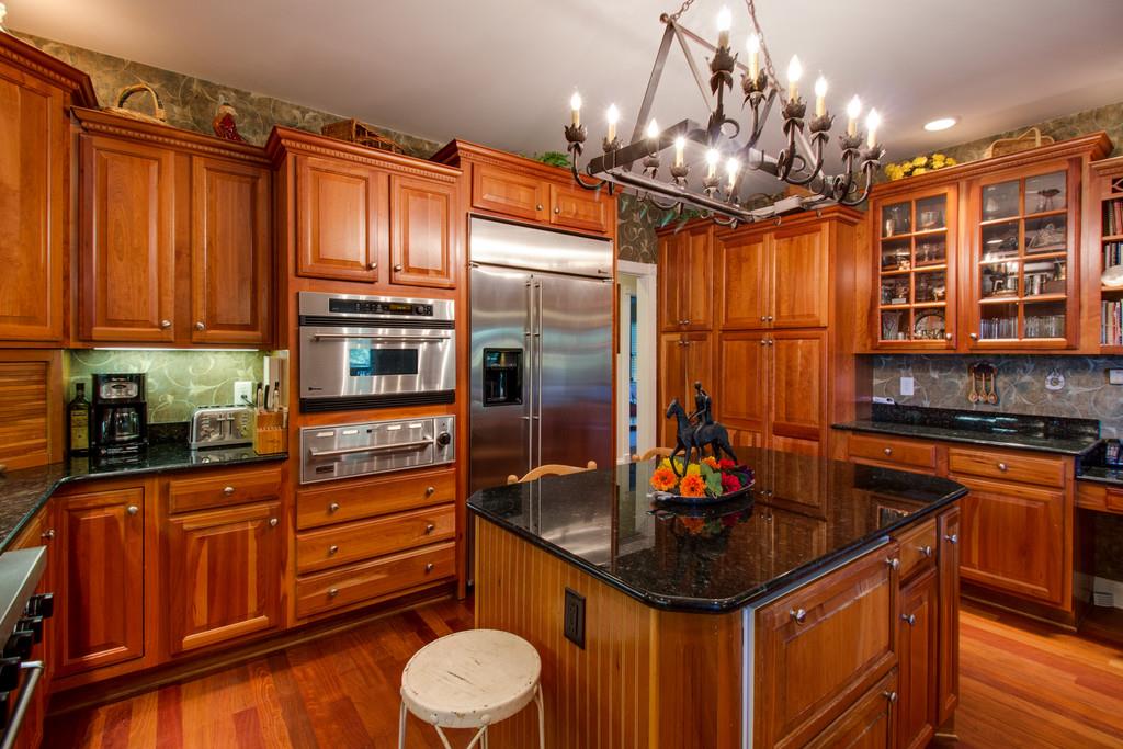 4670 Murfreesboro Road Franklin, TN 37067 - Photo 22 of 30 a kitchen with stainless steel appliances granite countertop a sink a stove and a wooden floors