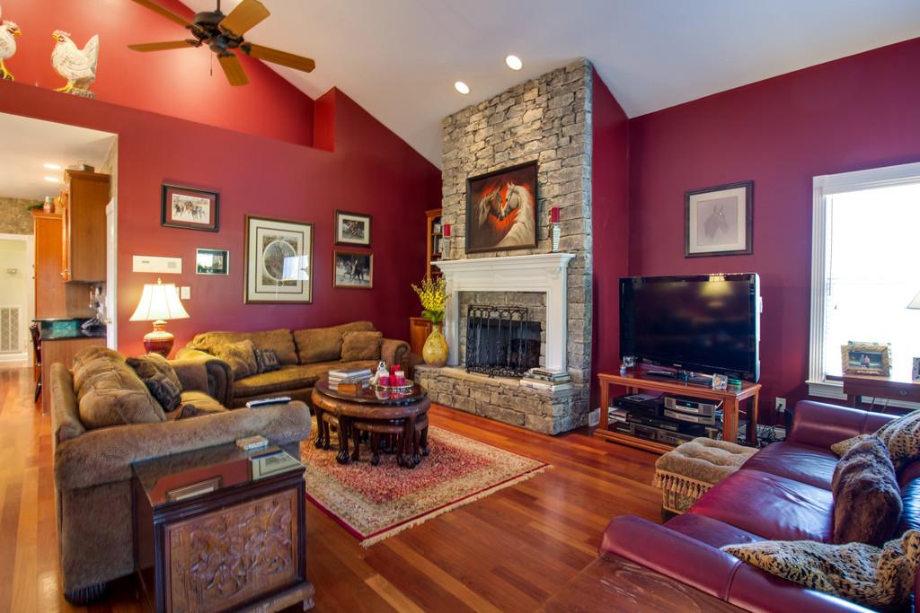 4670 Murfreesboro Road Franklin, TN 37067 - Photo 24 of 30 a living room with furniture a flat screen tv and a fireplace
