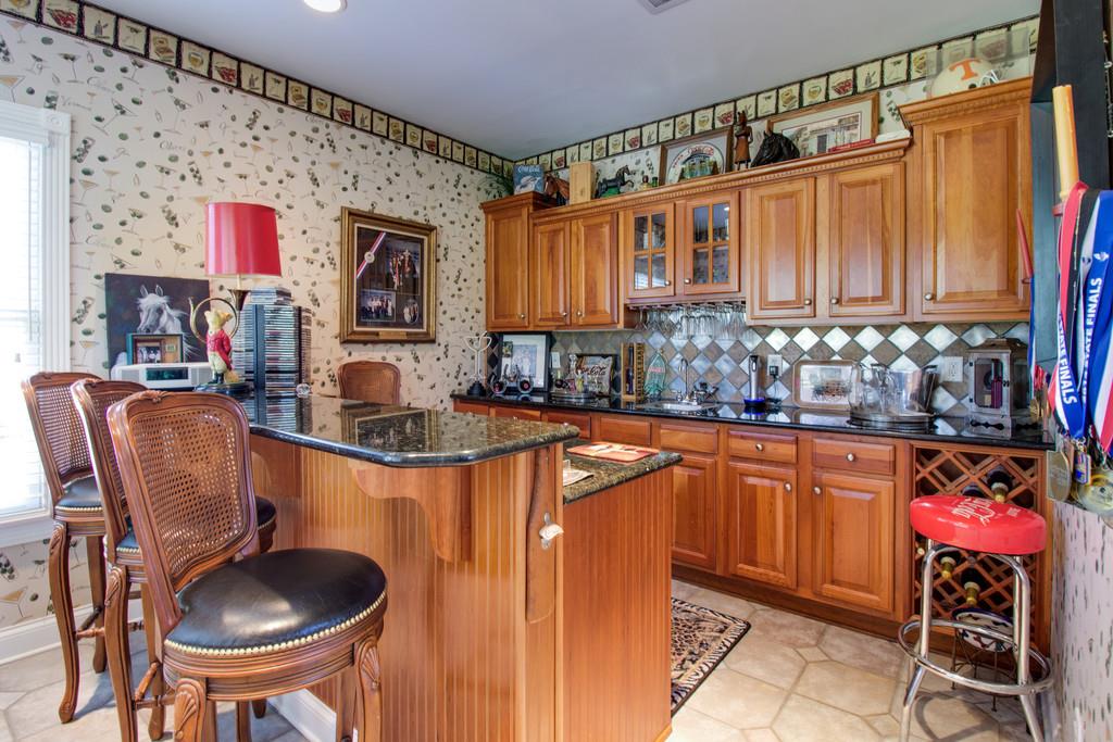 4670 Murfreesboro Road Franklin, TN 37067 - Photo 26 of 30 a kitchen with stainless steel appliances granite countertop a sink dishwasher and cabinets with wooden floor