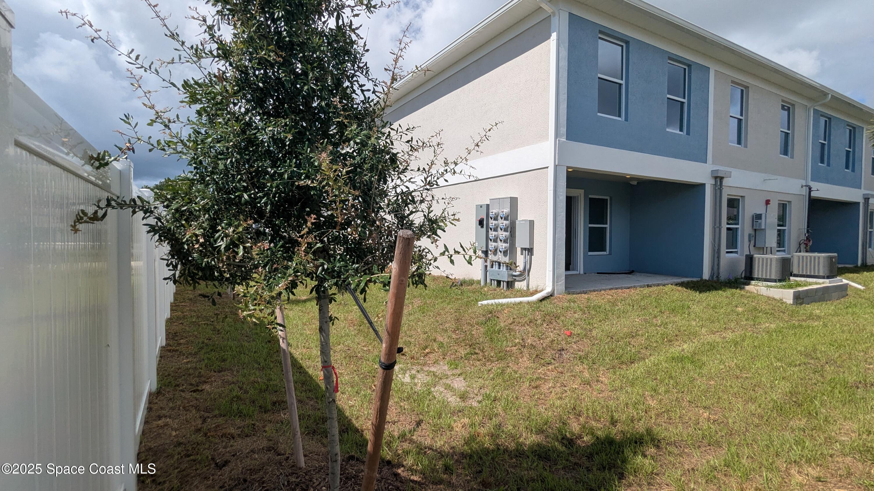 1625 Par Street, Unit 1106 Palm Bay, FL 32905 - Photo 31 of 32 a view of yellow house with a tree