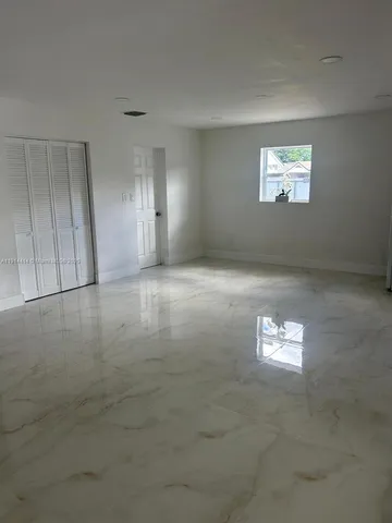 a kitchen with stainless steel appliances granite countertop a sink stove oven and white cabinets