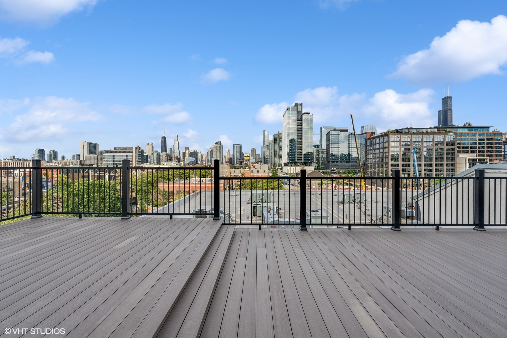401 North Aberdeen Street, Unit 2N Chicago, IL 60642 - Photo 35 of 37 a view of a roof with wooden floor and city view