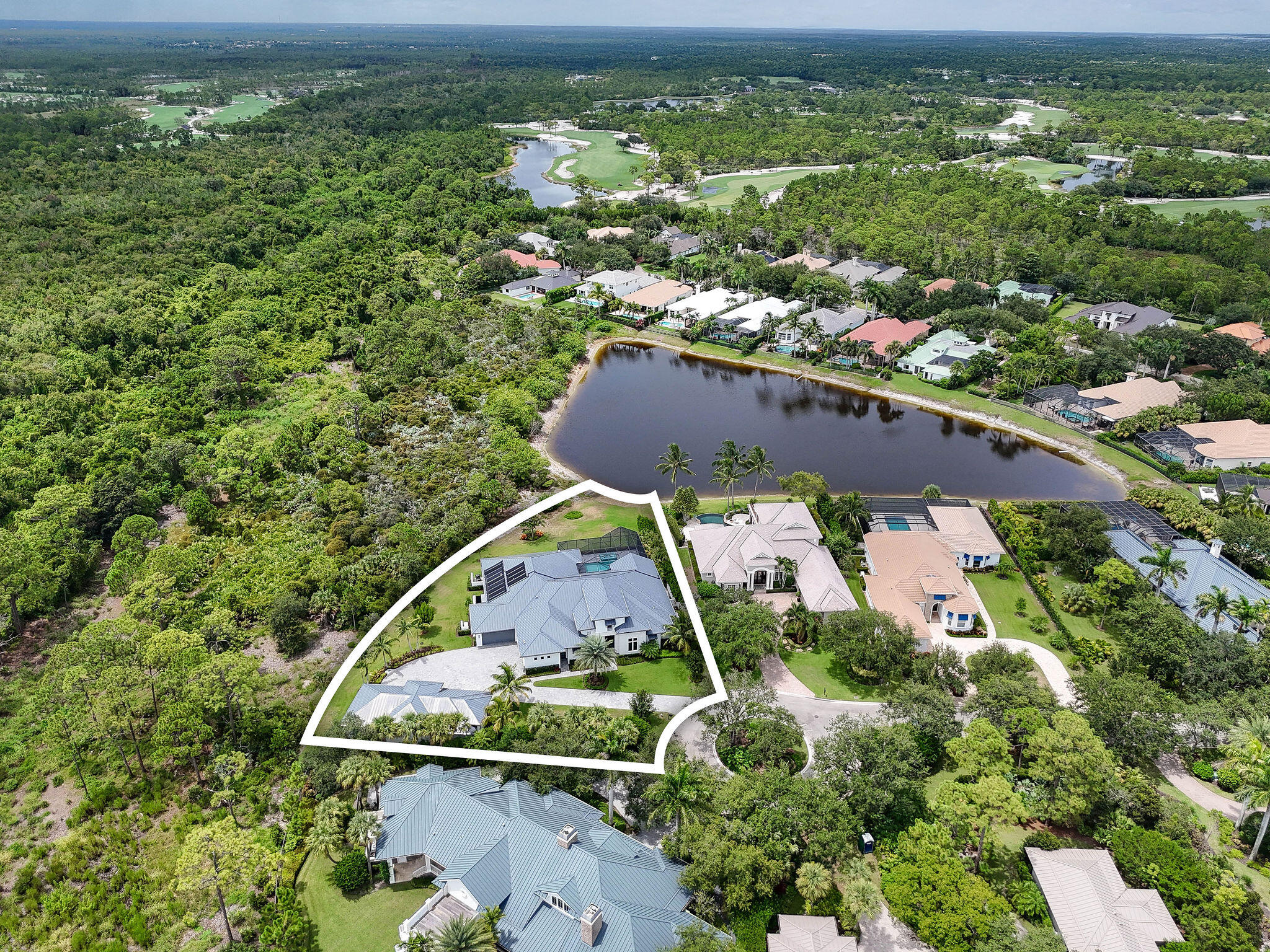 6219 Southeast Moss Ridge Pointe Hobe Sound, FL 33455 - Photo 105 of 108 an aerial view of a house with a yard and lake view