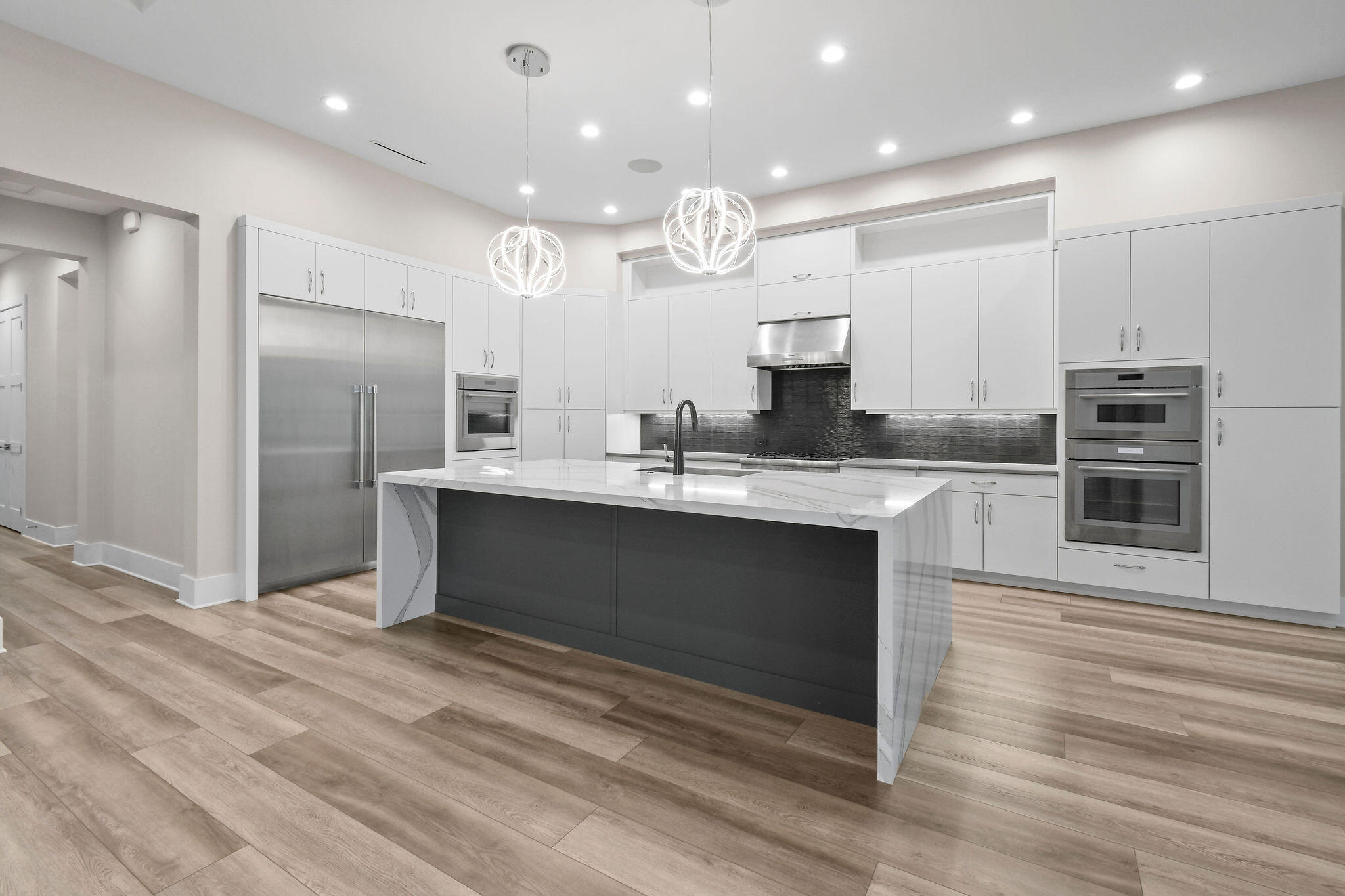 6219 Southeast Moss Ridge Pointe Hobe Sound, FL 33455 - Photo 17 of 108 a kitchen with kitchen island a sink stainless steel appliances and cabinets
