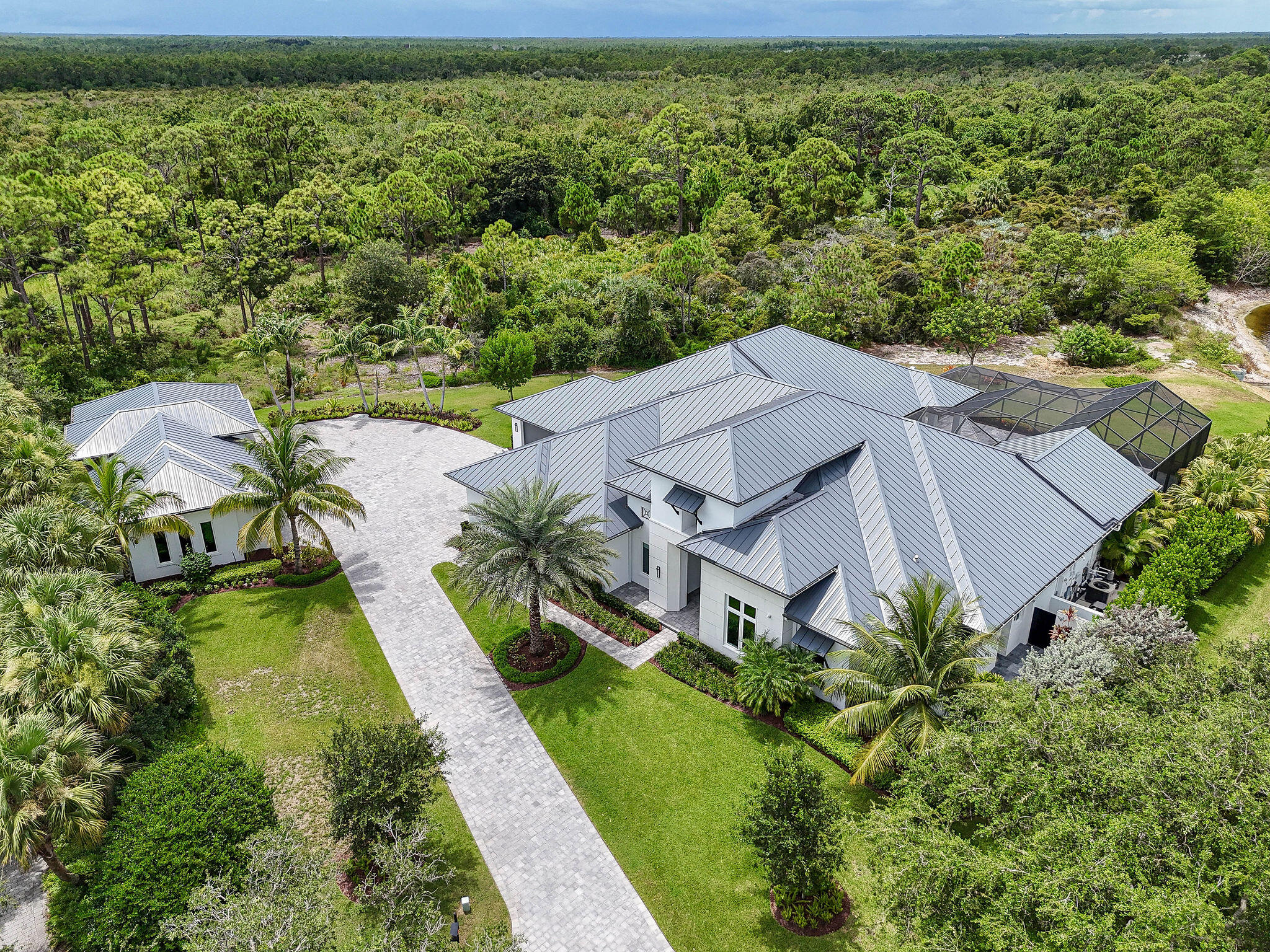 6219 Southeast Moss Ridge Pointe Hobe Sound, FL 33455 - Photo 2 of 108 an aerial view of a house with a garden