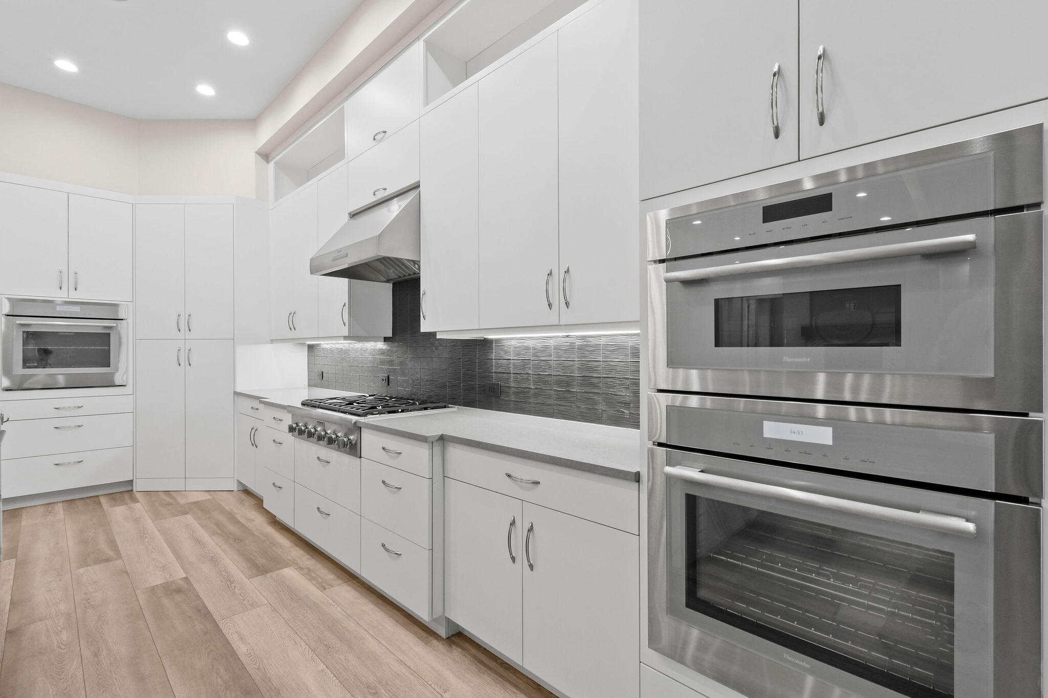 6219 Southeast Moss Ridge Pointe Hobe Sound, FL 33455 - Photo 22 of 108 a kitchen with granite countertop white cabinets stainless steel appliances and sink