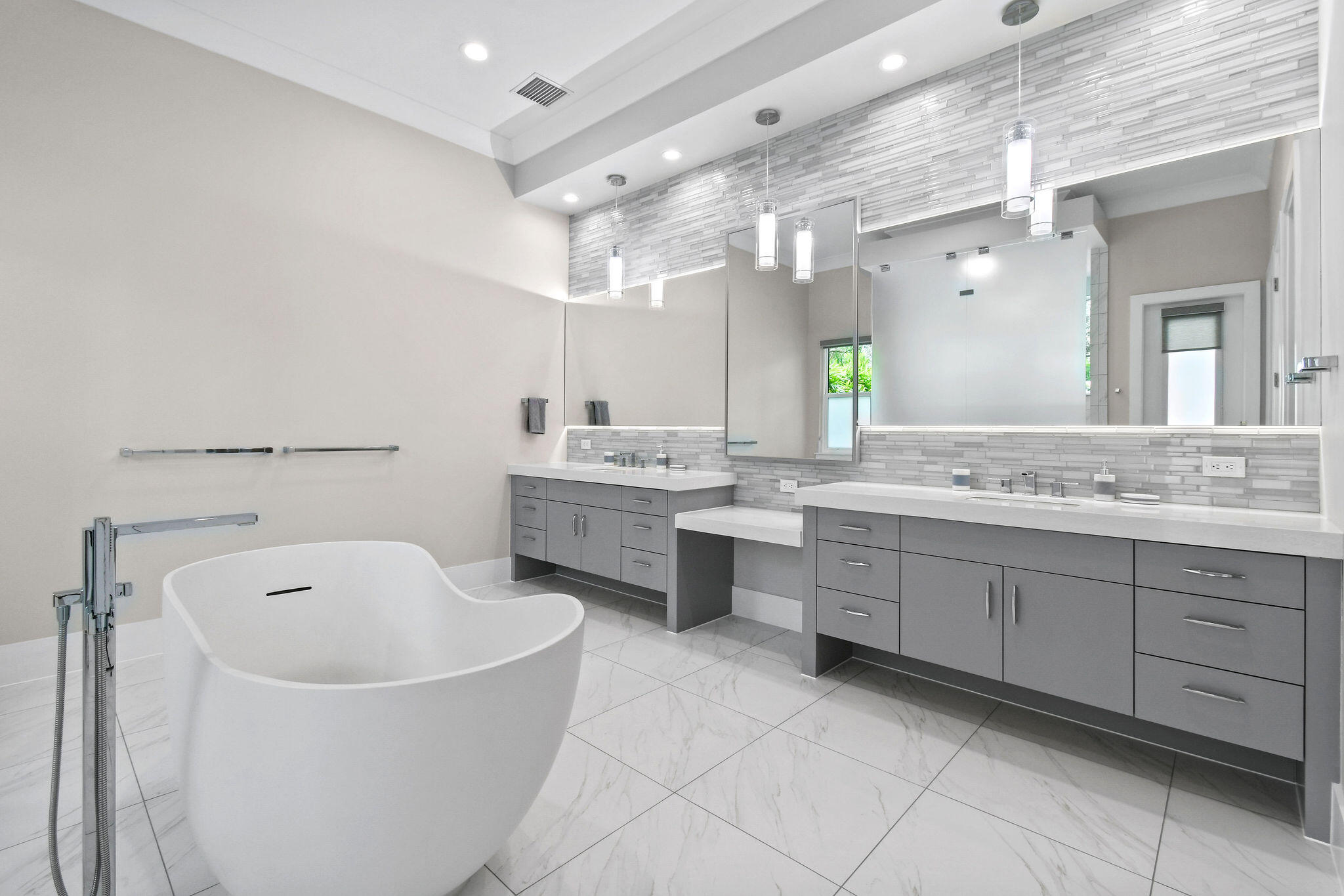 6219 Southeast Moss Ridge Pointe Hobe Sound, FL 33455 - Photo 32 of 108 a large bathroom with a double vanity sink mirror and bathtub