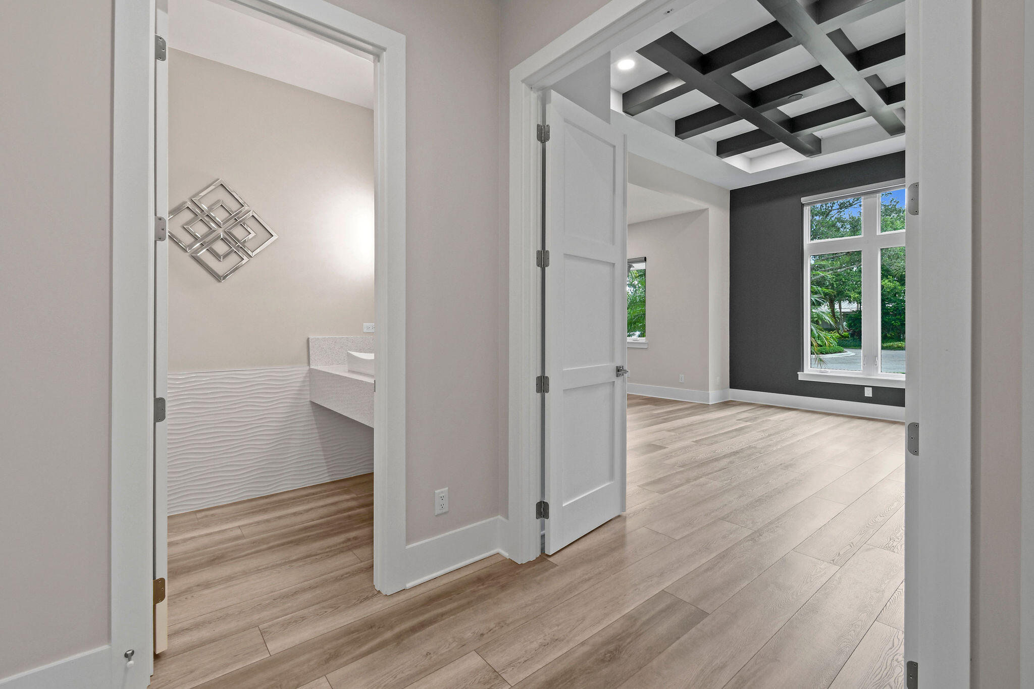 6219 Southeast Moss Ridge Pointe Hobe Sound, FL 33455 - Photo 40 of 108 a view of a hallway with wooden floor and a living room