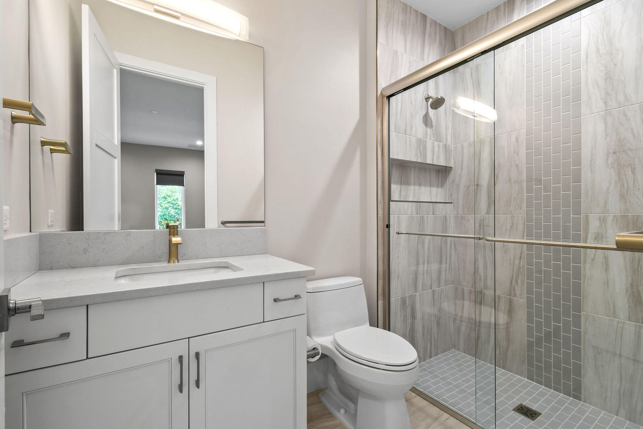 6219 Southeast Moss Ridge Pointe Hobe Sound, FL 33455 - Photo 47 of 108 a bathroom with a sink a toilet and shower