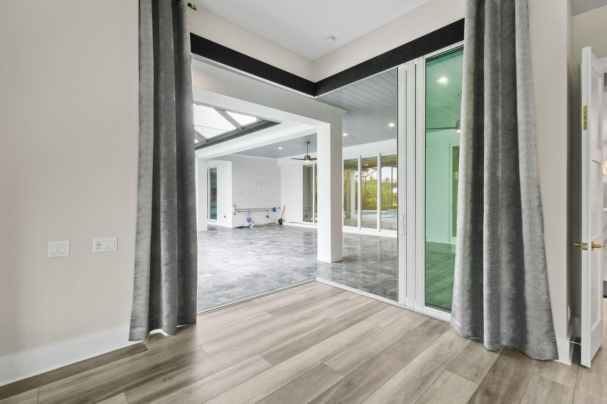 6219 Southeast Moss Ridge Pointe Hobe Sound, FL 33455 - Photo 65 of 108 a view of a hallway with wooden floor and a bathroom
