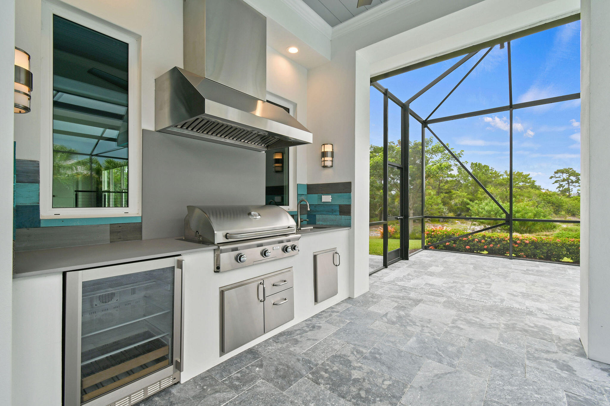 6219 Southeast Moss Ridge Pointe Hobe Sound, FL 33455 - Photo 84 of 108 a kitchen with stainless steel appliances granite countertop a stove a sink and a refrigerator